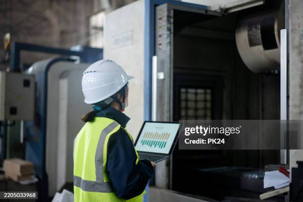 aisan female working on laptop in factory - aisan women stock pictures, royalty-free photos & images