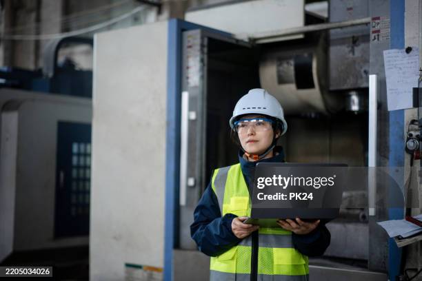 aisan female working on laptop in factory - aisan women stock pictures, royalty-free photos & images