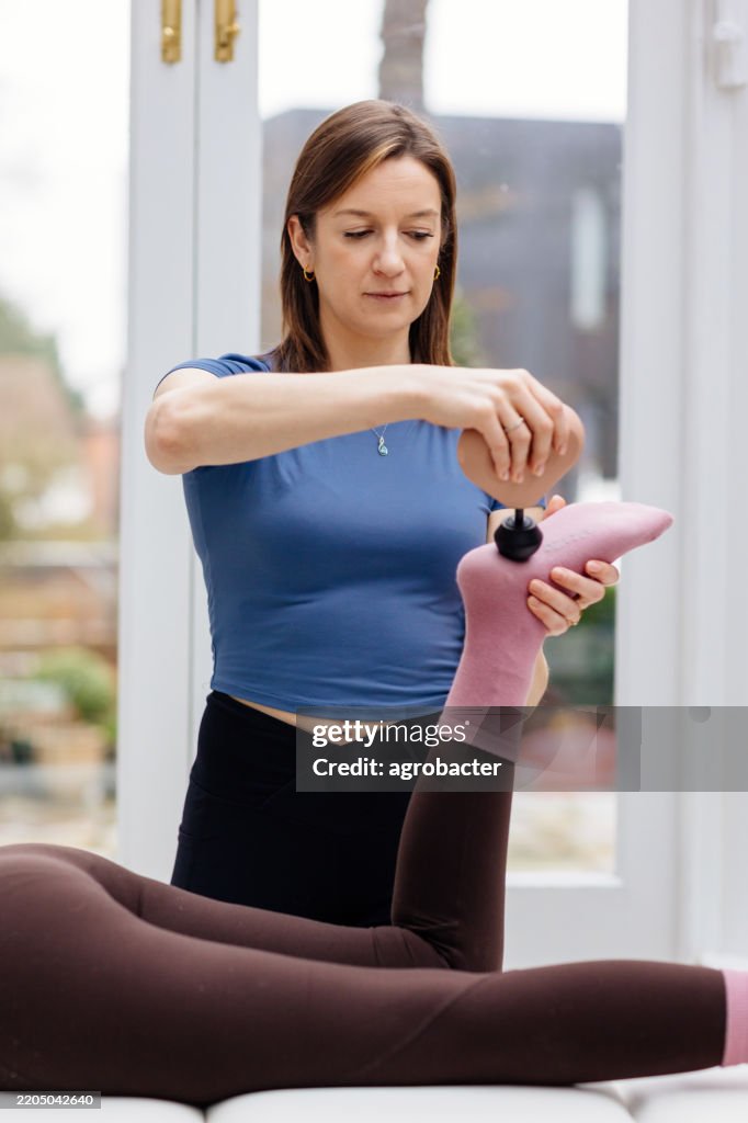 Formateur Masser une femme avec un pistolet de massage