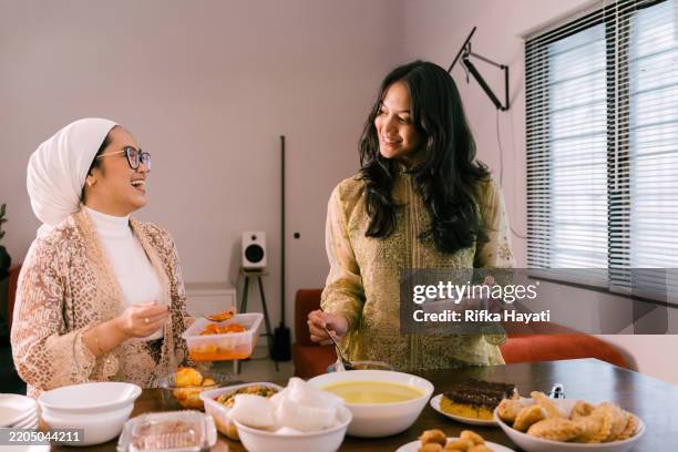 young beautiful woman preparing food for eid mubarak - eid ul fitr stock pictures, royalty-free photos & images