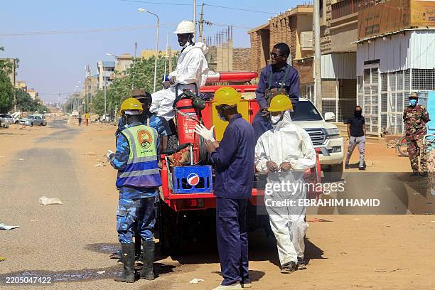 Graphic content / Sudanese rescue teams wait for the extraction of the remains of bodies that were found in a well in the East Nile district of...