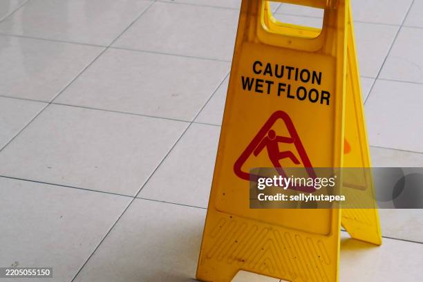 caution, slippery surface sign on wet floor - caution wet floor stock pictures, royalty-free photos & images