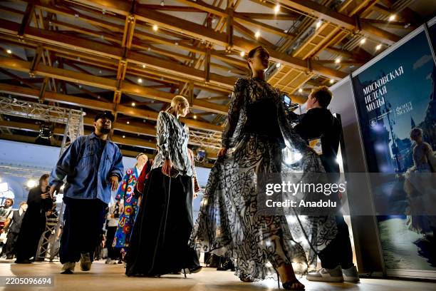Models make their final preparations behind the catwalk before the fashion show during the Moscow Fashion Week in Moscow, Russia on March 17, 2025.