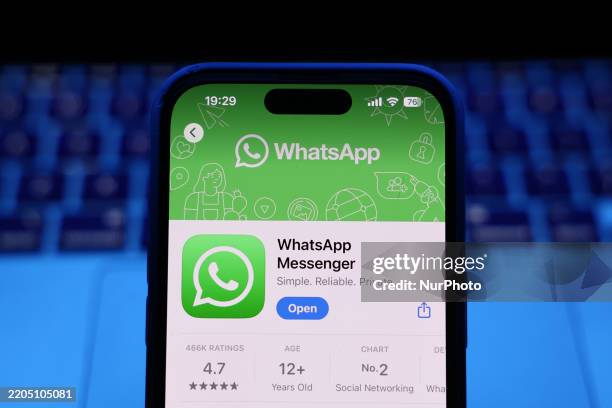 Laptop keyboard and WhatsApp on App Store displayed on a phone screen are seen in this illustration photo taken in Krakow, Poland on March 17, 2025.