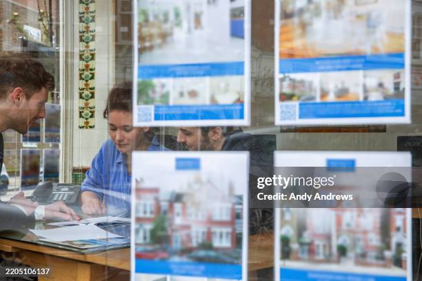 couple looking at houses for sale - estate agent stock pictures, royalty-free photos & images