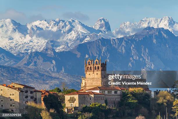 view of the church of nuestra señora de los ángeles with the picos de europa in the background - cantabria stock pictures, royalty-free photos & images