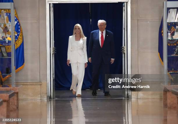 President Donald Trump walks with U.S. Attorney General Pam Bondi during a visit to the Justice Department March 14, 2025 in Washington, DC. As he...