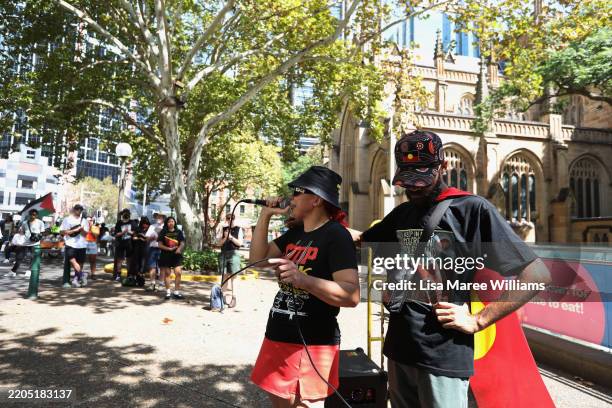 Activist Lizzie Jarrett and Paul Silva speak during a rally calling for improved treatment and rights for Indigenous Australians at Town Hall on...