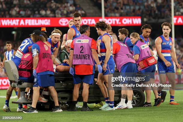 Western Bulldogs players check on Luke Cleary of the Bulldogs as he receives medical treatment during the round one AFL match between Western...