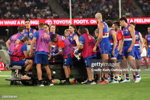 Western Bulldogs players check on Luke Cleary of the Bulldogs as he receives medical treatment during the round one AFL match between Western...