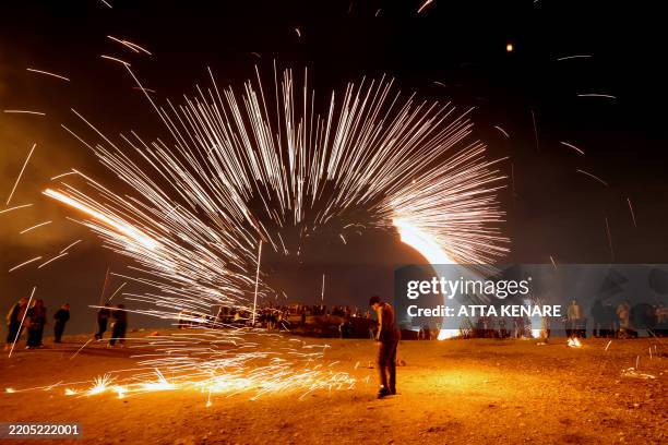 Iranians light fireworks during the Wednesday Fire feast, or Chaharshanbeh Soori, held annually on the last Wednesday eve before the Spring holiday...