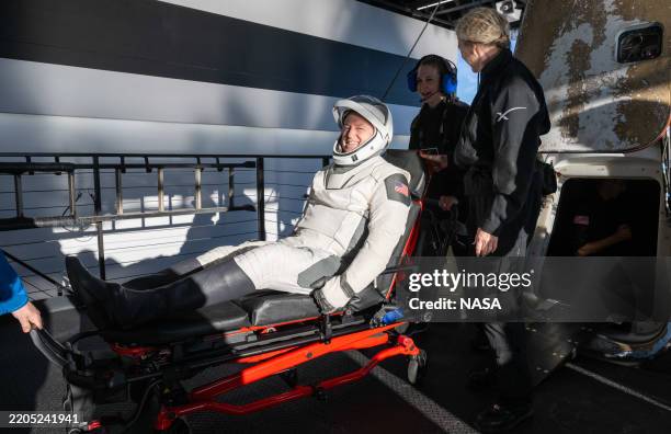 In this handout image provided by the National Aeronautics and Space Administration , NASA astronaut Butch Wilmore is helped out of the SpaceX Dragon...
