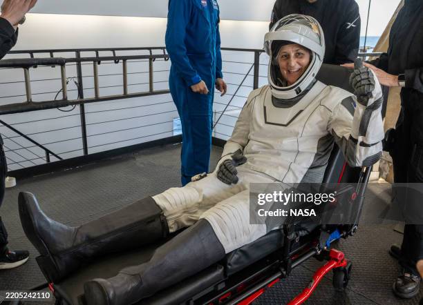In this handout image provided by the National Aeronautics and Space Administration , NASA astronaut Suni Williams is helped out of the SpaceX Dragon...