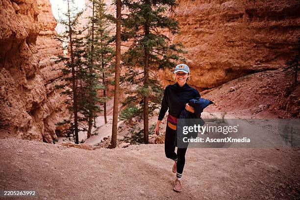 femme fait de la randonnée sur le sentier du canyon, bryce canyon - sud ouest américain photos et images de collection