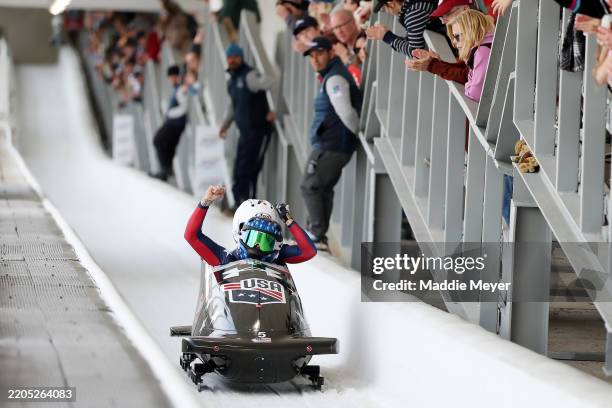 Kaillie Humphries Armbruster and Emily Renna of the United States react after crossing the finish line in heat 4 during the 2-woman bobsleigh on day...