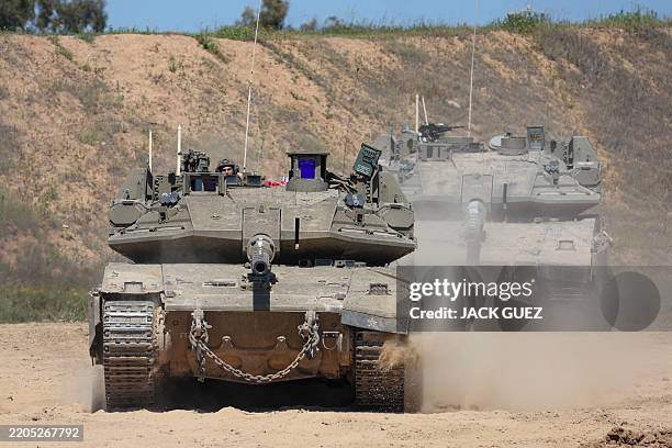 An Israeli soldier operates a tank at a position along Israel's southern border with the northern Gaza Strip on March 19, 2025. Israel on March 18...