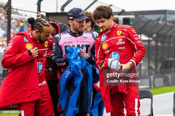 Lewis Hamilton of Great Britain and Ferrari, Charles Leclerc of Monaco and Ferrari and Pierre Gasly of France and Alpine F1 team chat during the...