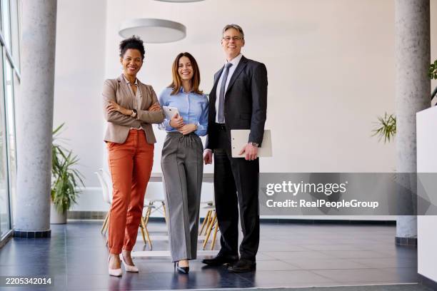 confident business team smiling at camera in modern office - black man full body portrait stock pictures, royalty-free photos & images