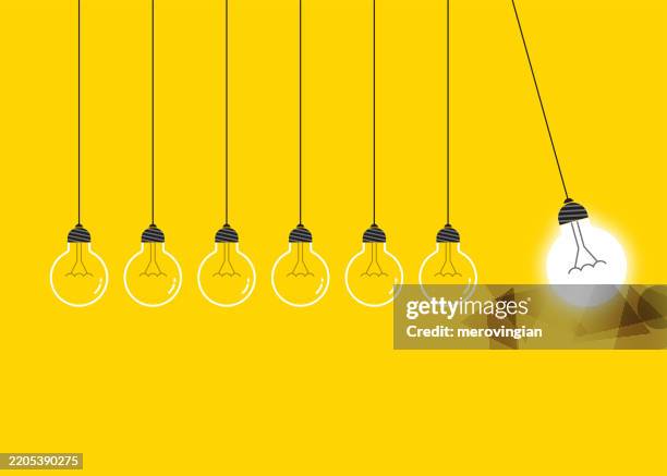 newton's cradle with glowing light bulb - pendulum stock illustrations