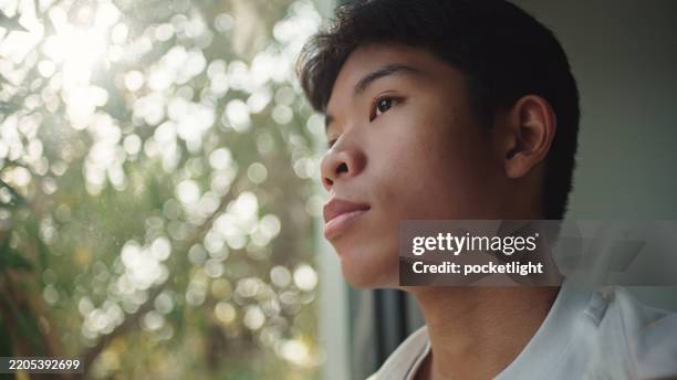 teenager looking through the window. - teen imagination stock pictures, royalty-free photos & images