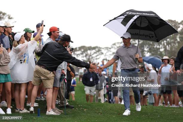 Rory McIlroy of Northern Ireland interacts with fans as he walks to the 12th tee during the final round of THE PLAYERS Championship on the Stadium...