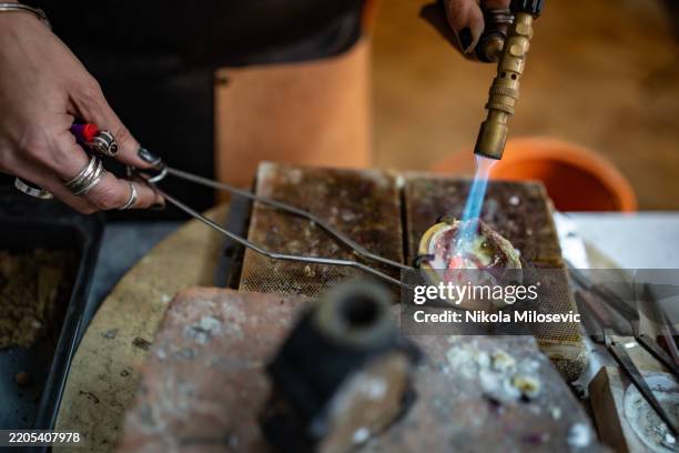 close-up of a metalworker heating material with a blowtorch tool - workbench stock pictures, royalty-free photos & images
