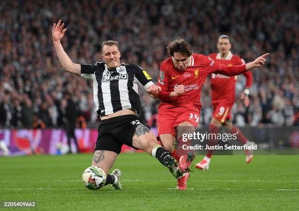 Federico Chiesa of Liverpool scores his team's first goal whilst under pressure from Dan Burn of Newcastle United during the Carabao Cup Final...