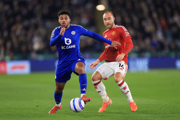 James Justin of Leicester City is challenged by Christian Eriksen of Manchester United during the Premier League match between Leicester City FC and...