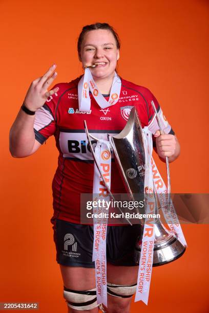 Sarah Beckett of Gloucester-Hartpury poses for a portrait with her winners medal and the Premiership Women's Rugby Trophy after Gloucester-Hartpury...
