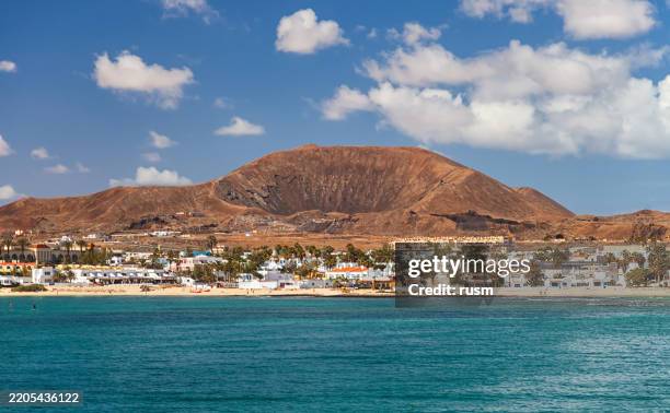 summer view of corralejo town from sea, fuerteventura, canary islands - dormant volcano stock pictures, royalty-free photos & images