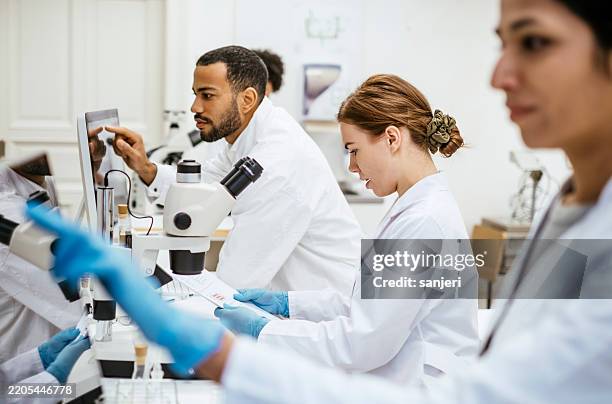 diverse stem students conducting research in university laboratory - mikrobiologi bildbanksfoton och bilder