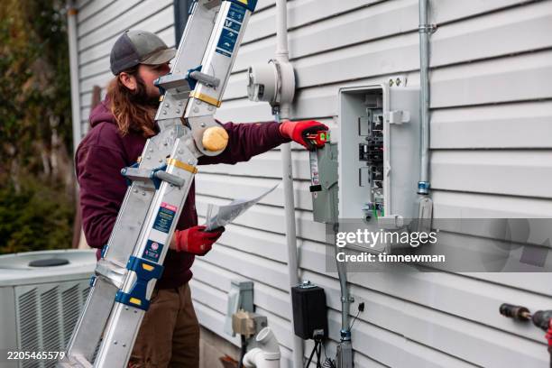 electrician wiring up solar panel system on home - fuse box stock pictures, royalty-free photos & images