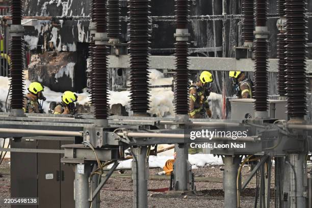 Members of the Fire Brigade attend the scene following a major fire at an electrical substation at Heathrow on March 21, 2025 in London, England. A...