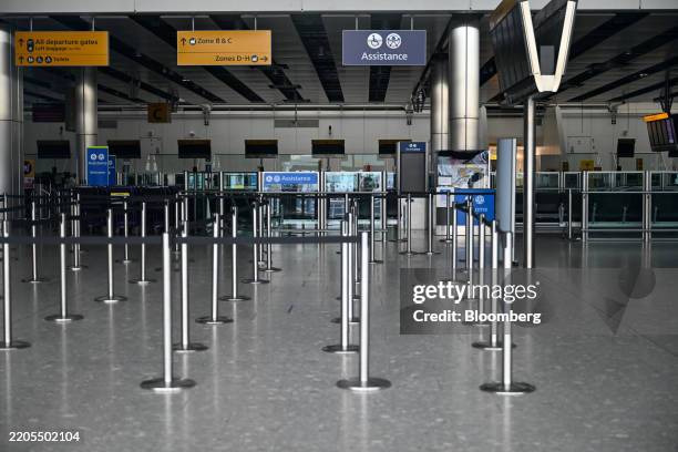 Empty check-in desks at Terminal 4 at London Heathrow Airport in London, UK, on Friday, March 21, 2025. London's Heathrow airport will close all day...