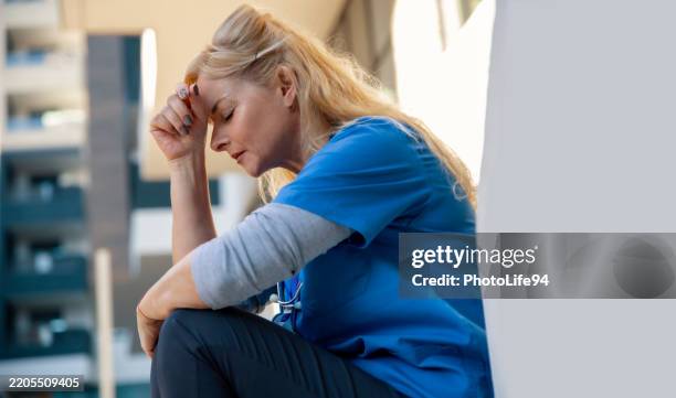 woman doctor with headache under physical pressure - tired healthcare worker stock pictures, royalty-free photos & images