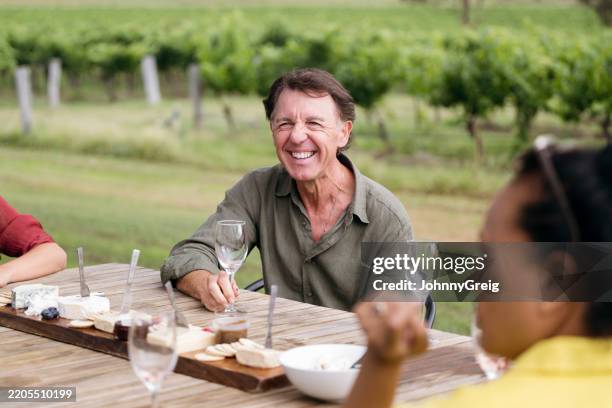 senior male wine taster enjoying food, drink, and company - pokolbin stock pictures, royalty-free photos & images