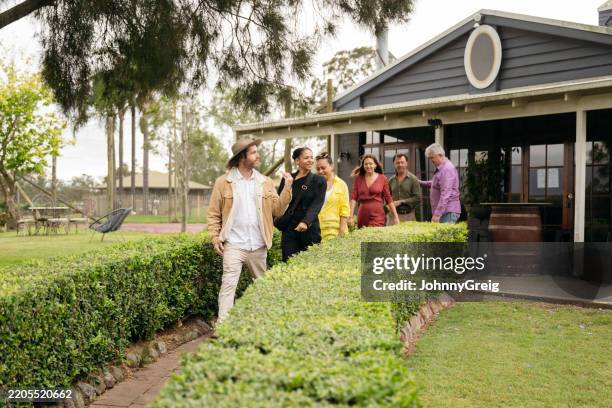 winery tour guide leading guests outdoors to visit vineyard - pokolbin stock pictures, royalty-free photos & images
