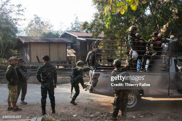 Soldiers from an armed group fighting the burmese army who took power in a coup in February 2021, get in a truck to go on a patrol.