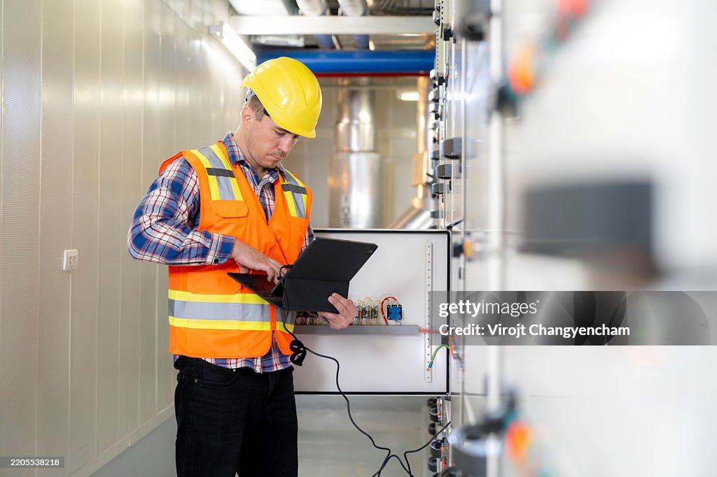 Checing Power Electrical Engineer Checking Power At Control Room Using Digital Tablet ...