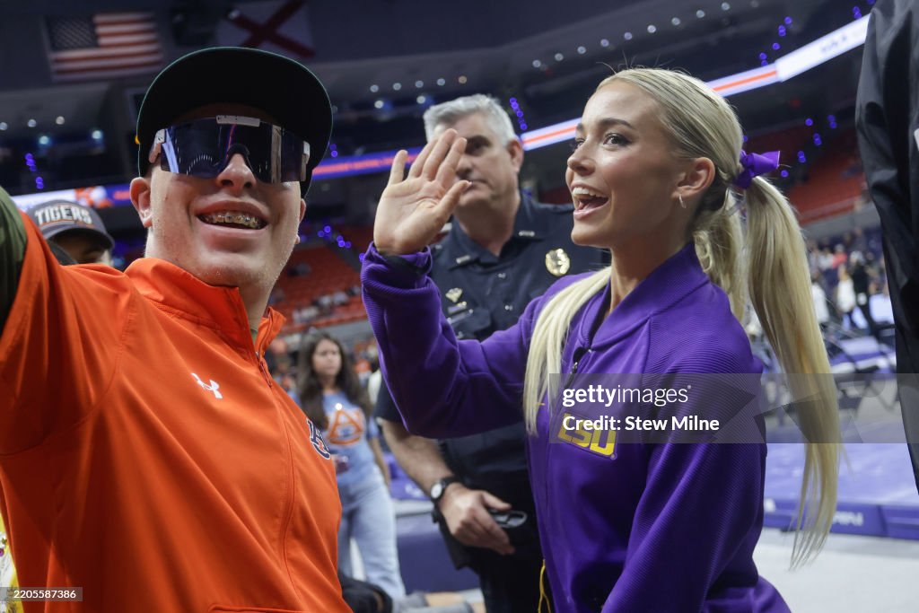 Perrin Rittner Lsu Olivia Dunne of the LSU Tigers takes a photo with a fan following a ...