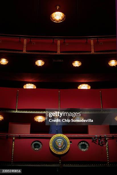 President Donald Trump looks down from the Presidential Box in the Opera House at the John F. Kennedy Center for the Performing Arts as he...