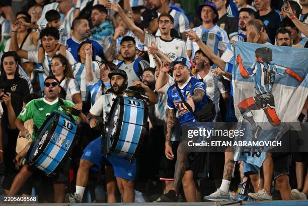 Argentina fans cheer for their team before the start of the 2026 FIFA World Cup South American qualifiers football match between Uruguay and...