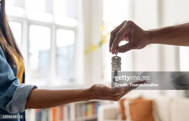 real estate agent giving the keys of a new house to a woman - home sweet home stock pictures, royalty-free photos & images