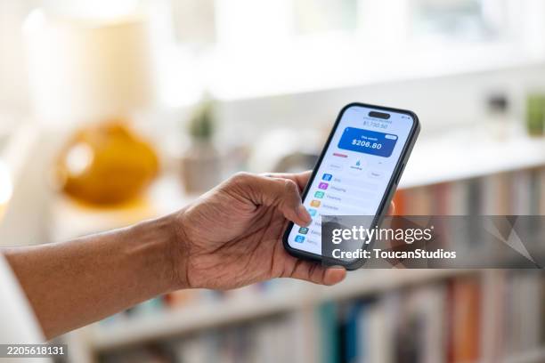 close-up on a man checking the balance on his digital wallet - bank account uk stock pictures, royalty-free photos & images