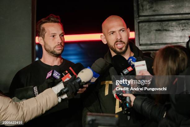 Andrew Tate and his brother Tristan Tate talk to the media outside their residence on March 23, 2025 in Bucharest, Romania. Andrew Tate and his...