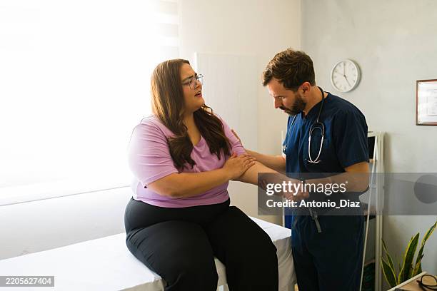 Healthcare professional examining arm of overweight patient during medical consultation in doctor's office