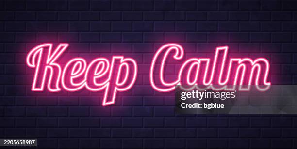 keep calm - glowing neon text on brick wall background - keep calm stock illustrations
