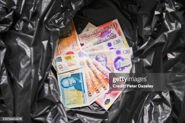 pound notes in plastic rubbish sack. - fifty pound note stock pictures, royalty-free photos & images