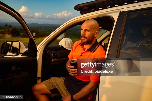 Australian engineer taking a break in his car during sunset Australian engineer taking a break in his car during sunset