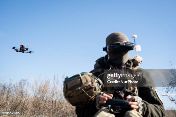 Ukrainian soldier performs a trial with an FPV drone in the region of Kharkiv, Ukraine, on March 19, 2025.